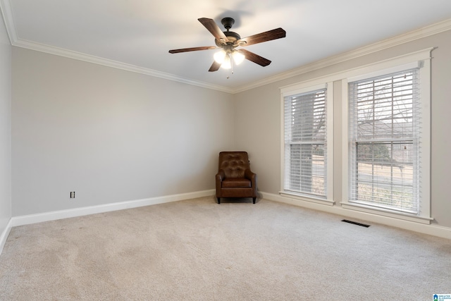 unfurnished room featuring carpet floors, ornamental molding, and ceiling fan