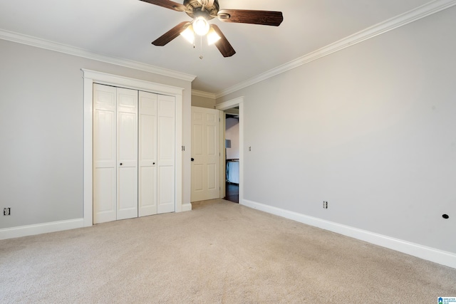 unfurnished bedroom with crown molding, a closet, ceiling fan, and carpet