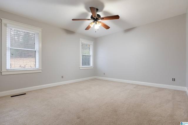 empty room featuring carpet flooring and ceiling fan