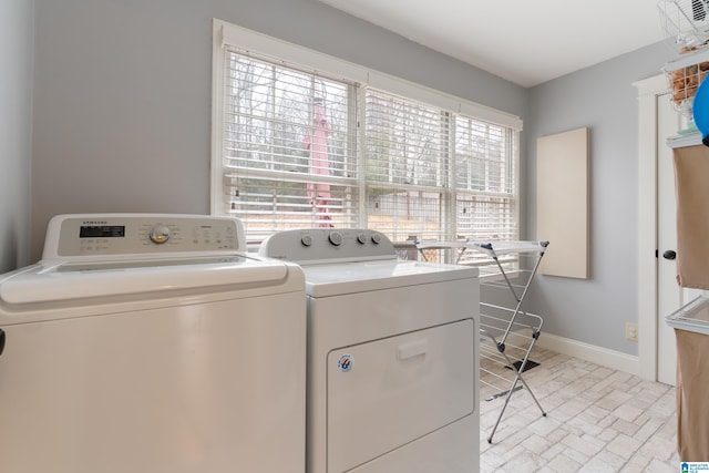 laundry area with a wealth of natural light and independent washer and dryer