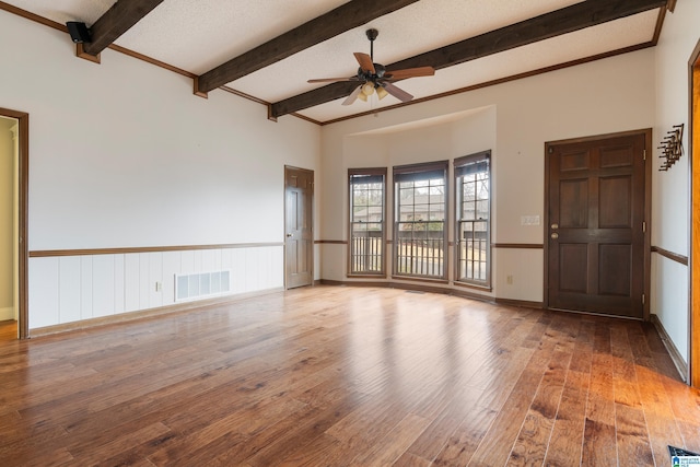 spare room featuring ceiling fan, beam ceiling, a textured ceiling, and light wood-type flooring