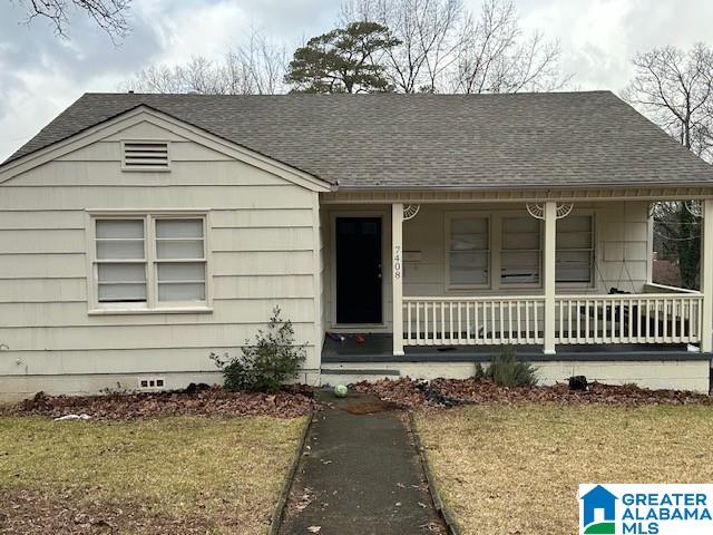 bungalow-style house featuring a porch and a front yard