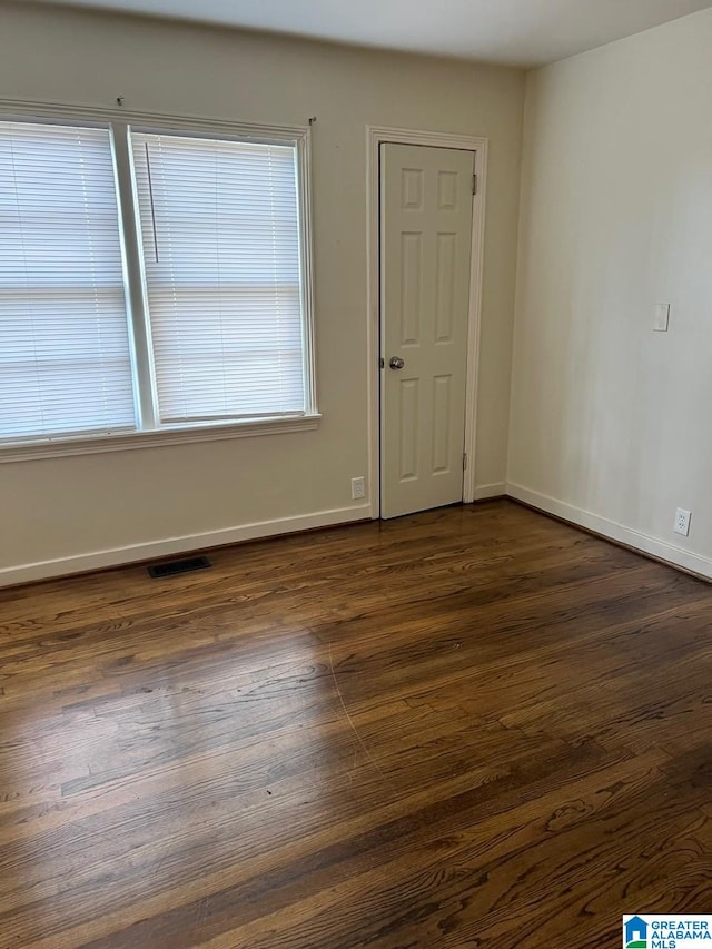 spare room featuring dark hardwood / wood-style floors