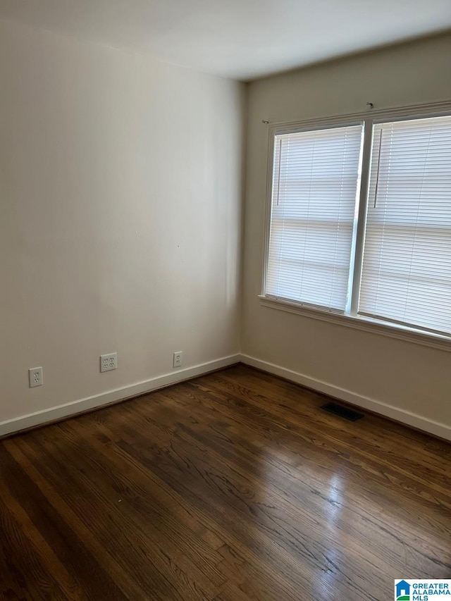 unfurnished room with dark hardwood / wood-style floors