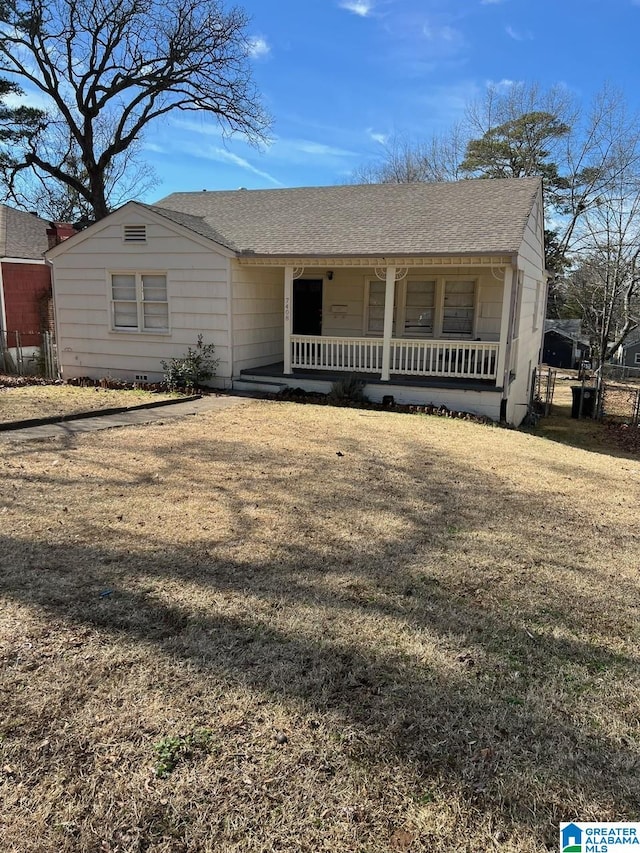 view of front of home with a porch and a front yard