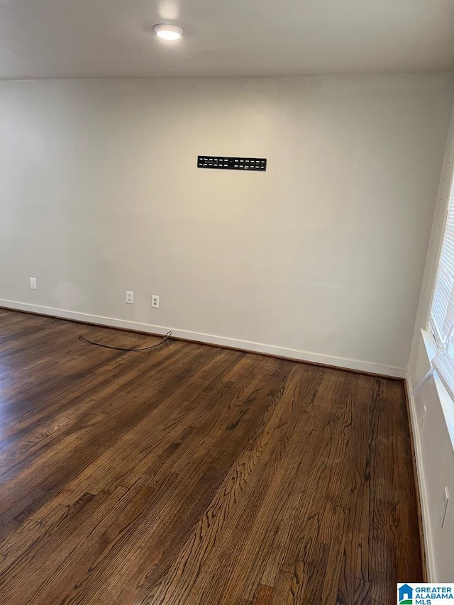 unfurnished room featuring dark wood-type flooring