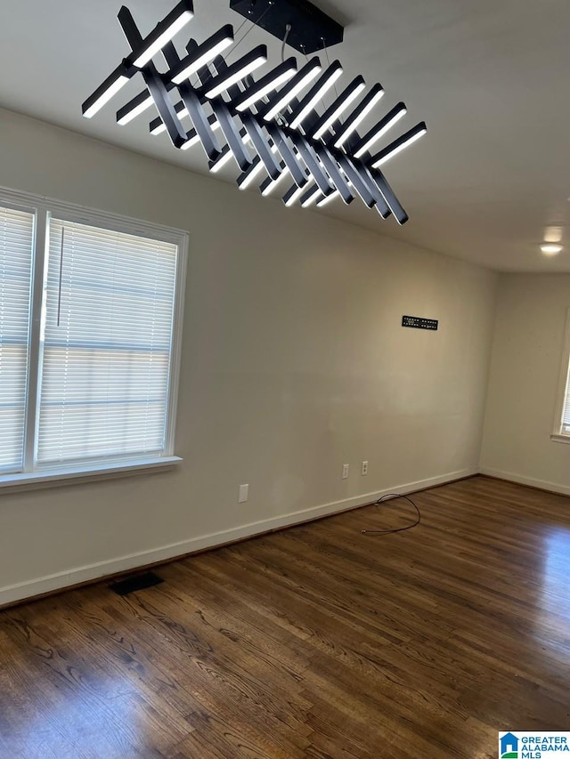 empty room with dark hardwood / wood-style floors