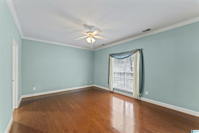 spare room featuring hardwood / wood-style floors, ornamental molding, and ceiling fan