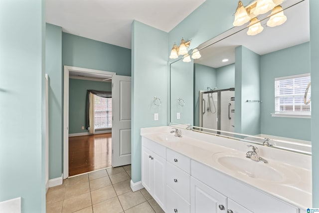 bathroom featuring tile patterned flooring, vanity, and walk in shower