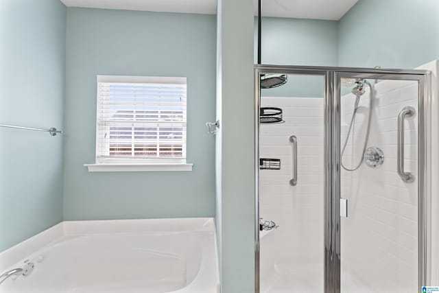 bathroom featuring independent shower and bath