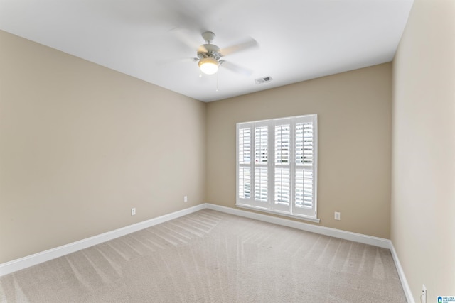 carpeted spare room with ceiling fan