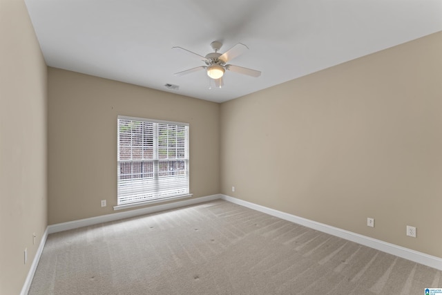 empty room with light colored carpet and ceiling fan