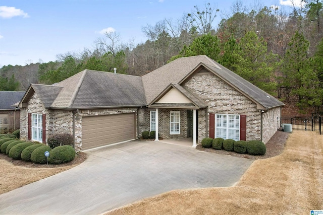 view of front of property with a garage and central air condition unit