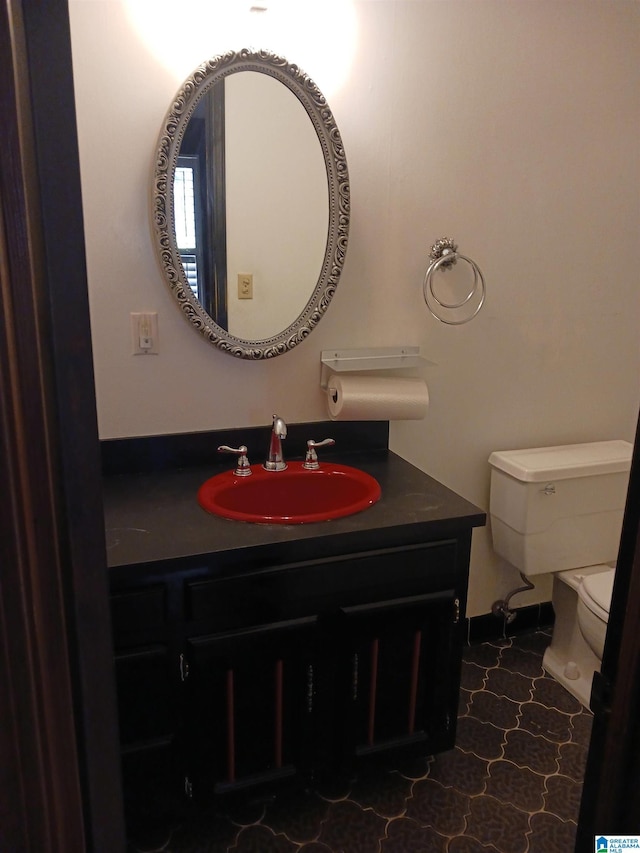 bathroom featuring vanity and toilet