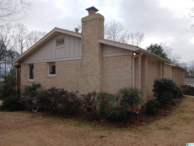 view of side of property with a lawn