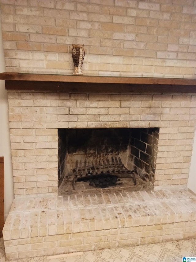 room details featuring a brick fireplace