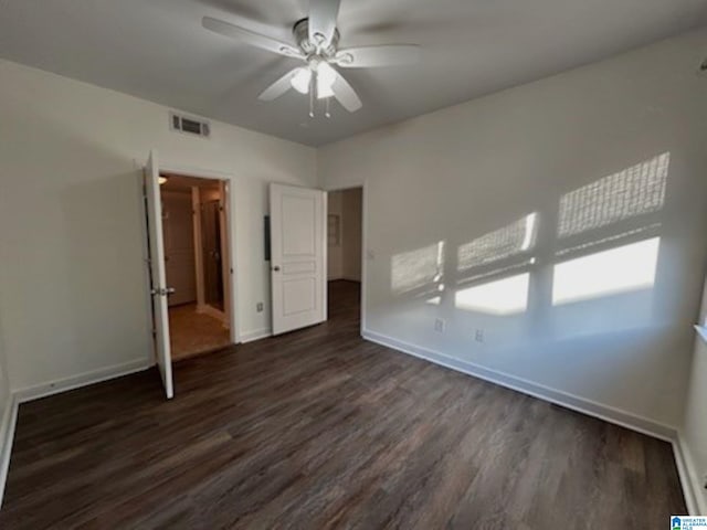 unfurnished bedroom featuring dark hardwood / wood-style flooring and ceiling fan