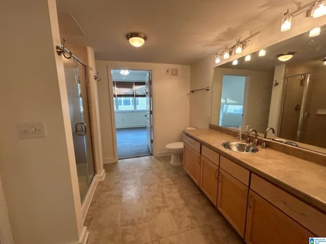 bathroom featuring vanity, toilet, and an enclosed shower