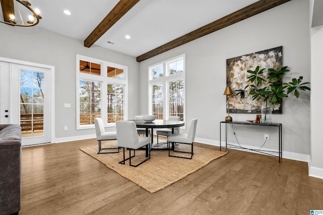 dining room with beam ceiling, a chandelier, and hardwood / wood-style floors