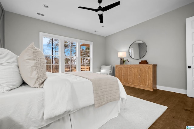 bedroom with ceiling fan and dark hardwood / wood-style flooring