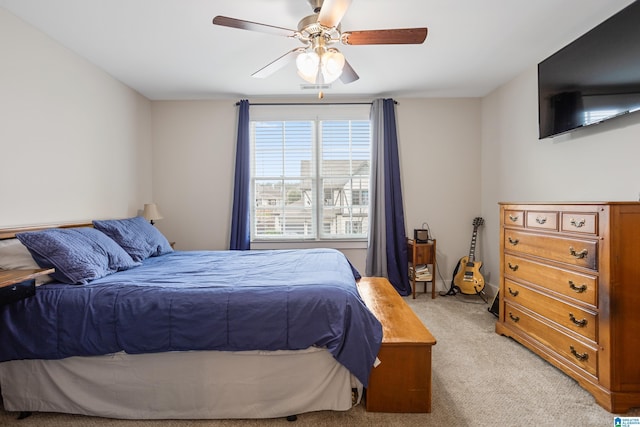 bedroom with ceiling fan and light carpet