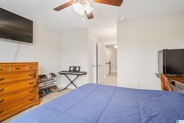 bedroom with light carpet and ceiling fan