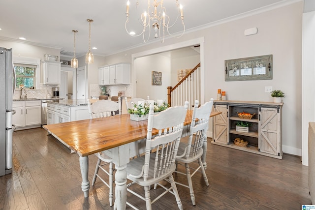 dining room with ornamental molding, dark wood-type flooring, sink, and a chandelier