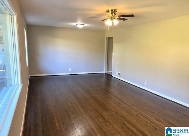 unfurnished room featuring dark hardwood / wood-style flooring and ceiling fan