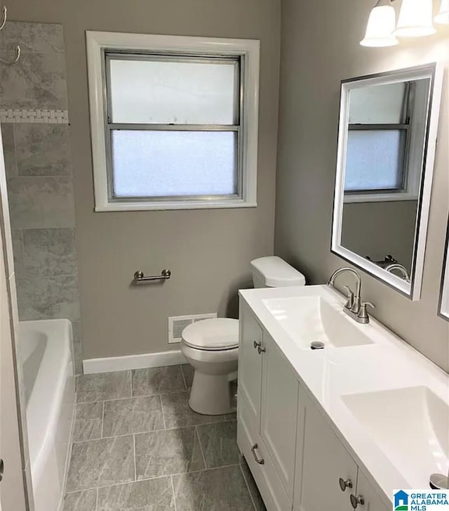 full bathroom featuring vanity, toilet, and  shower combination