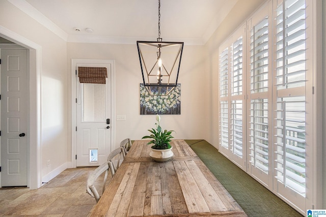 dining area with crown molding and an inviting chandelier