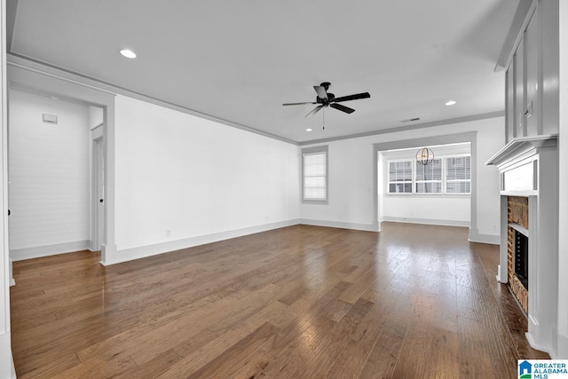 unfurnished living room with hardwood / wood-style flooring, ceiling fan, and crown molding