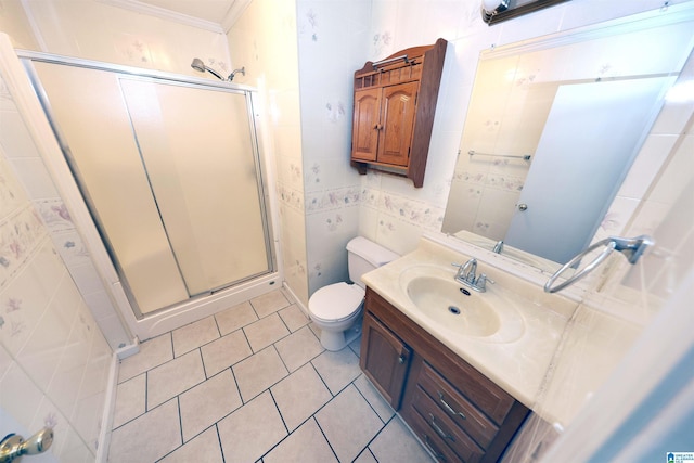 bathroom featuring toilet, an enclosed shower, tile walls, vanity, and tile patterned flooring