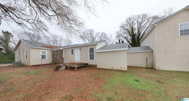 back of property featuring a yard and central AC unit