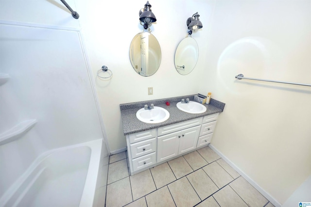 bathroom featuring tile patterned floors, vanity, and a bath