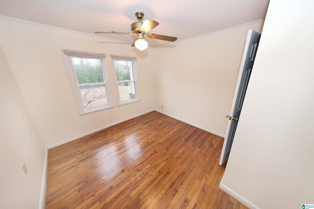 spare room with crown molding, hardwood / wood-style flooring, and ceiling fan