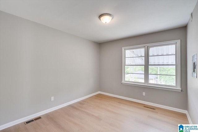 empty room with light hardwood / wood-style flooring