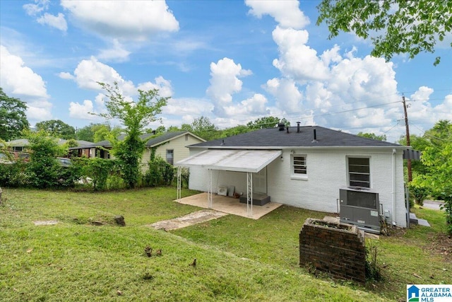 back of property featuring a patio area and a lawn