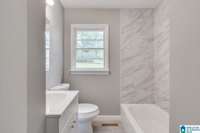 bathroom with vanity, a bath, and toilet