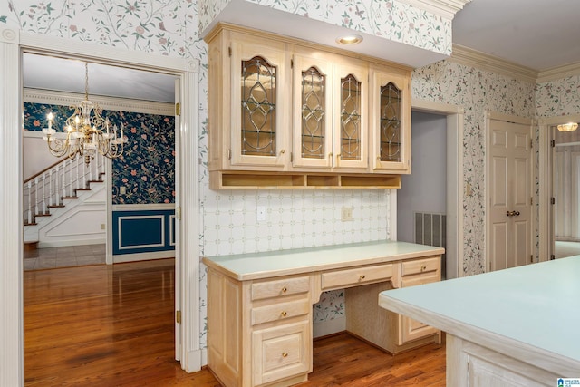 kitchen with hardwood / wood-style flooring, ornamental molding, decorative light fixtures, a chandelier, and light brown cabinets