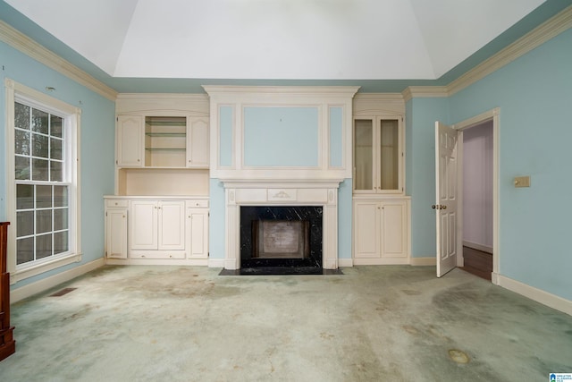 unfurnished living room with light carpet, ornamental molding, lofted ceiling, and a premium fireplace