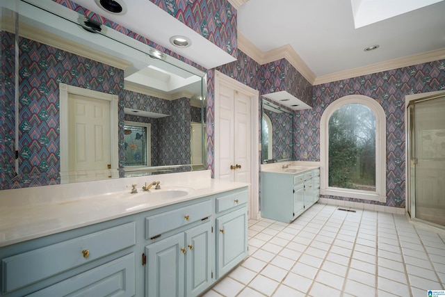 bathroom featuring tile patterned floors, ornamental molding, and vanity