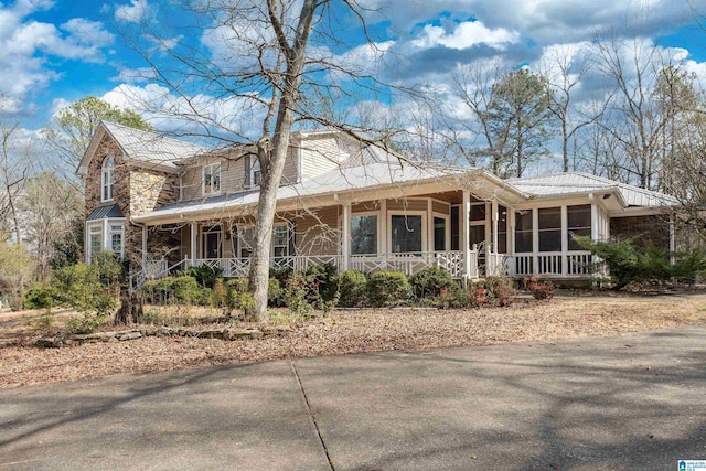 view of front of home featuring a sunroom and covered porch