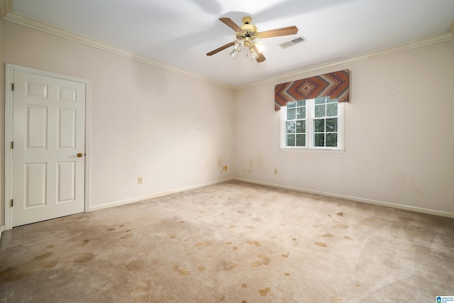 spare room featuring ornamental molding, carpet floors, and ceiling fan