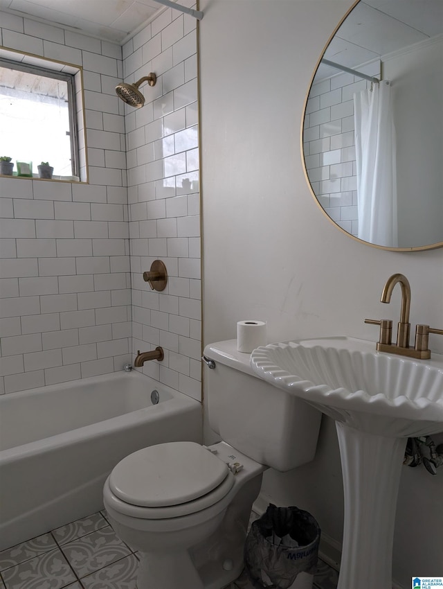 bathroom with shower / tub combo with curtain, tile patterned floors, and toilet