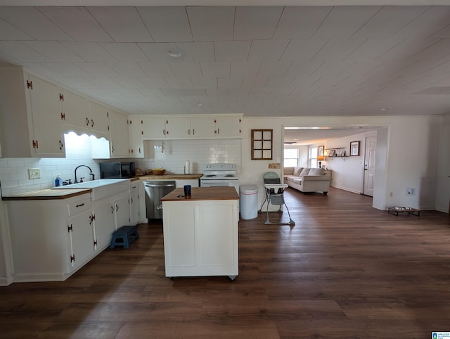 kitchen featuring a kitchen island, white cabinetry, sink, stainless steel dishwasher, and white electric range oven