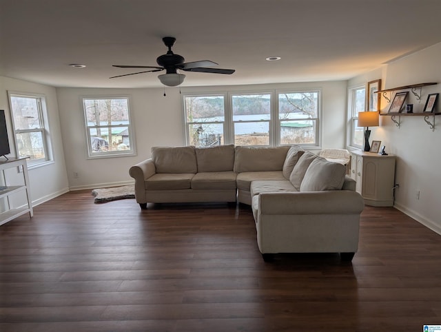 living room featuring dark hardwood / wood-style flooring and ceiling fan