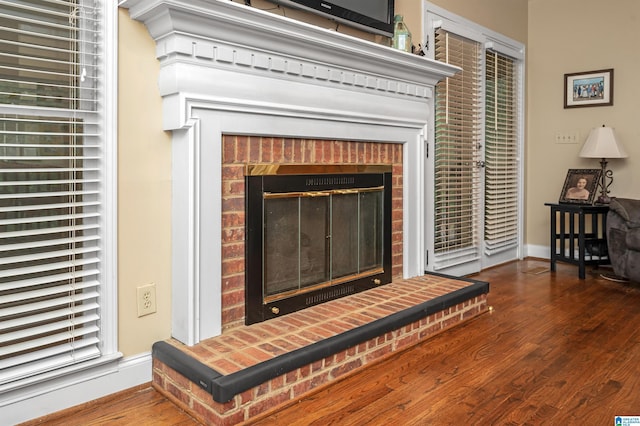 interior details featuring wood-type flooring and a fireplace