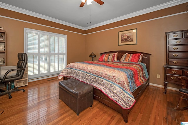 bedroom featuring crown molding, hardwood / wood-style floors, and ceiling fan