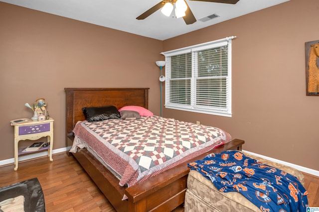 bedroom with hardwood / wood-style floors and ceiling fan