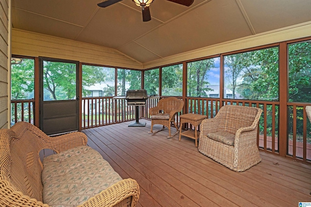 sunroom / solarium with ceiling fan and vaulted ceiling